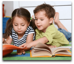 Girl & Boy Reading Book Two children are reading a book together.